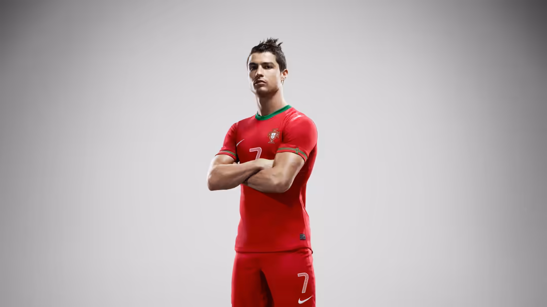 Professional football athlete in red jersey with number 7, arms crossed in confident pose against neutral gray background stu