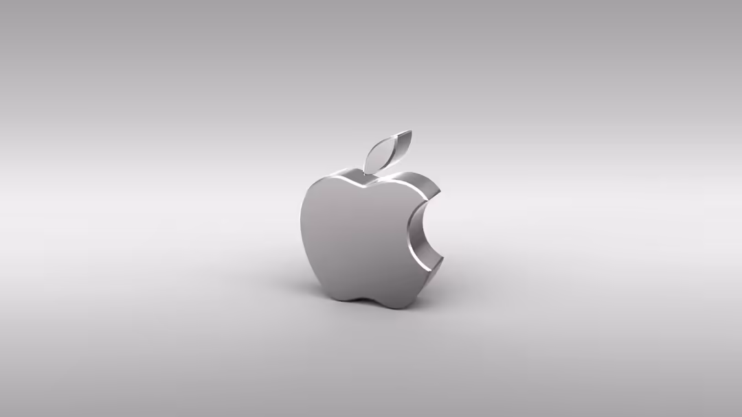 Metallic silver Apple logo with iconic bite mark on minimalist gray background with soft lighting and shadow