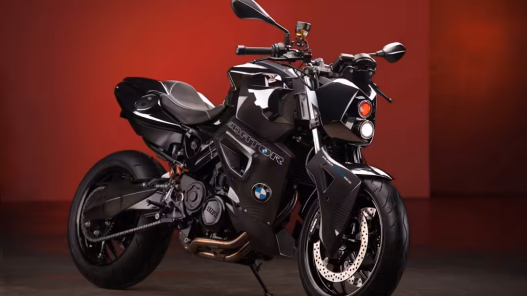 Sleek black sport motorcycle with white accents displayed against vibrant red background in professional studio setting