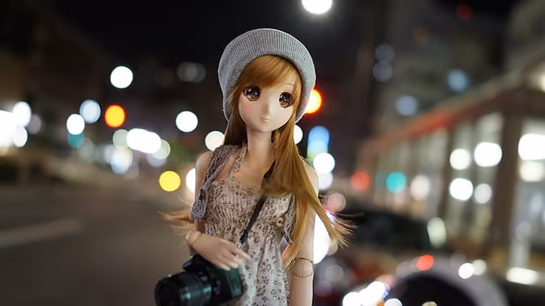Anime girl in gray beanie and cardigan holding camera on night city street with bokeh lights and urban scenery behind her