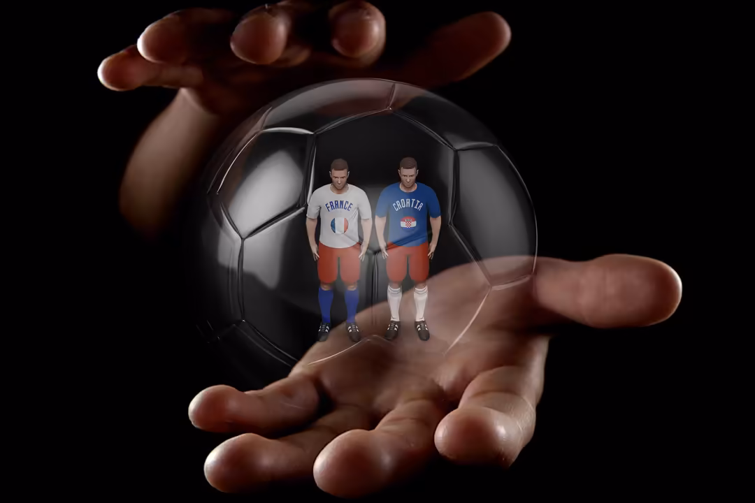 Hand holding a glossy black and white soccer ball with two football players inside wearing France and Croatia jerseys against