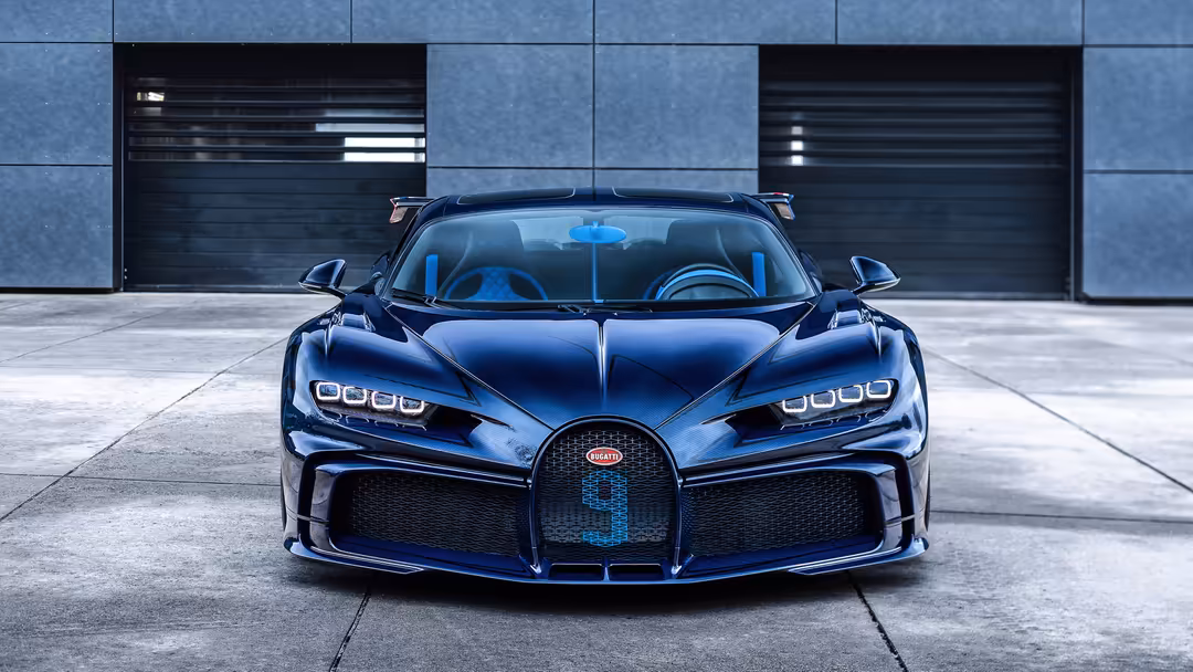 Stunning blue Bugatti Chiron Pur Sport supercar parked in front of modern architecture with sleek styling and iconic design e
