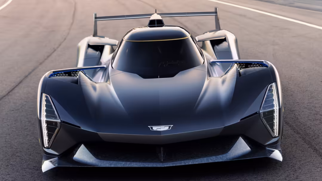 Front view of a sleek black Cadillac Project GTP prototype race car on a track with aerodynamic design and racing livery