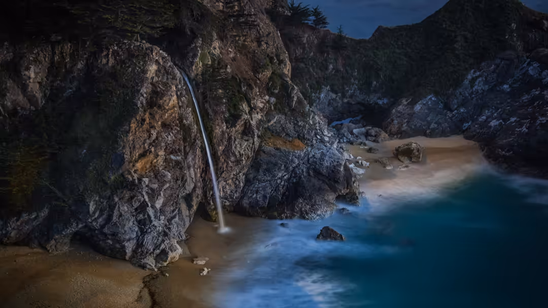 A serene coastal cove with a delicate waterfall cascading down moss-covered rocky cliffs into turquoise waters, sandy beach,