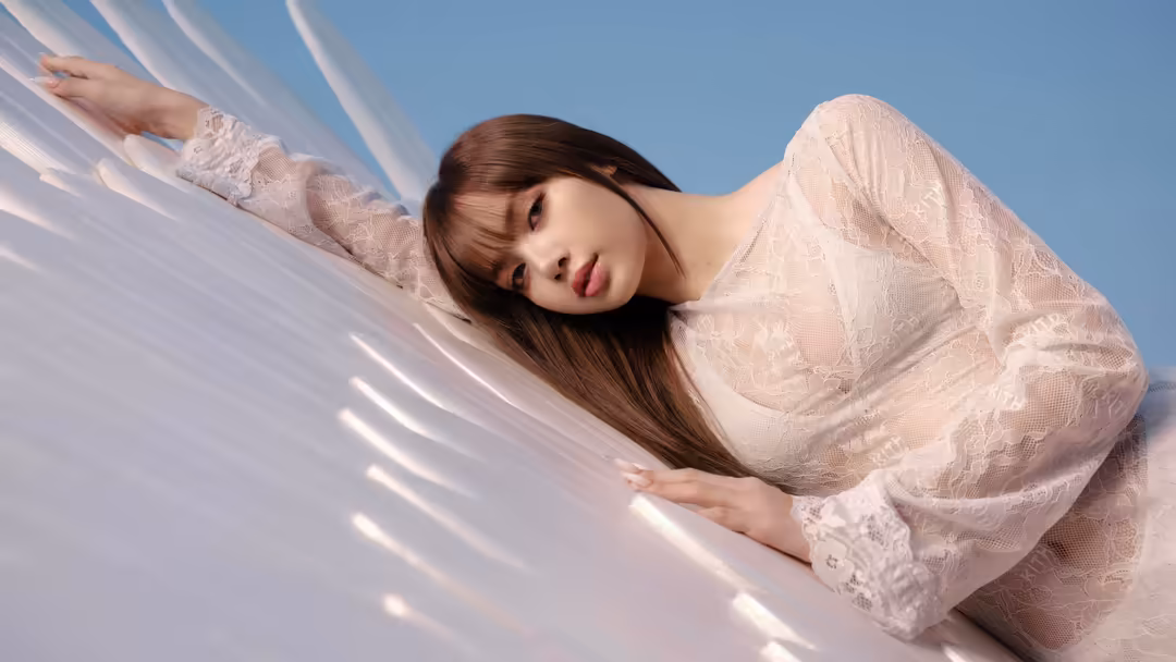 Lisa in delicate white lace top reclining gracefully against clear blue sky with soft sunlight creating peaceful serene aesth