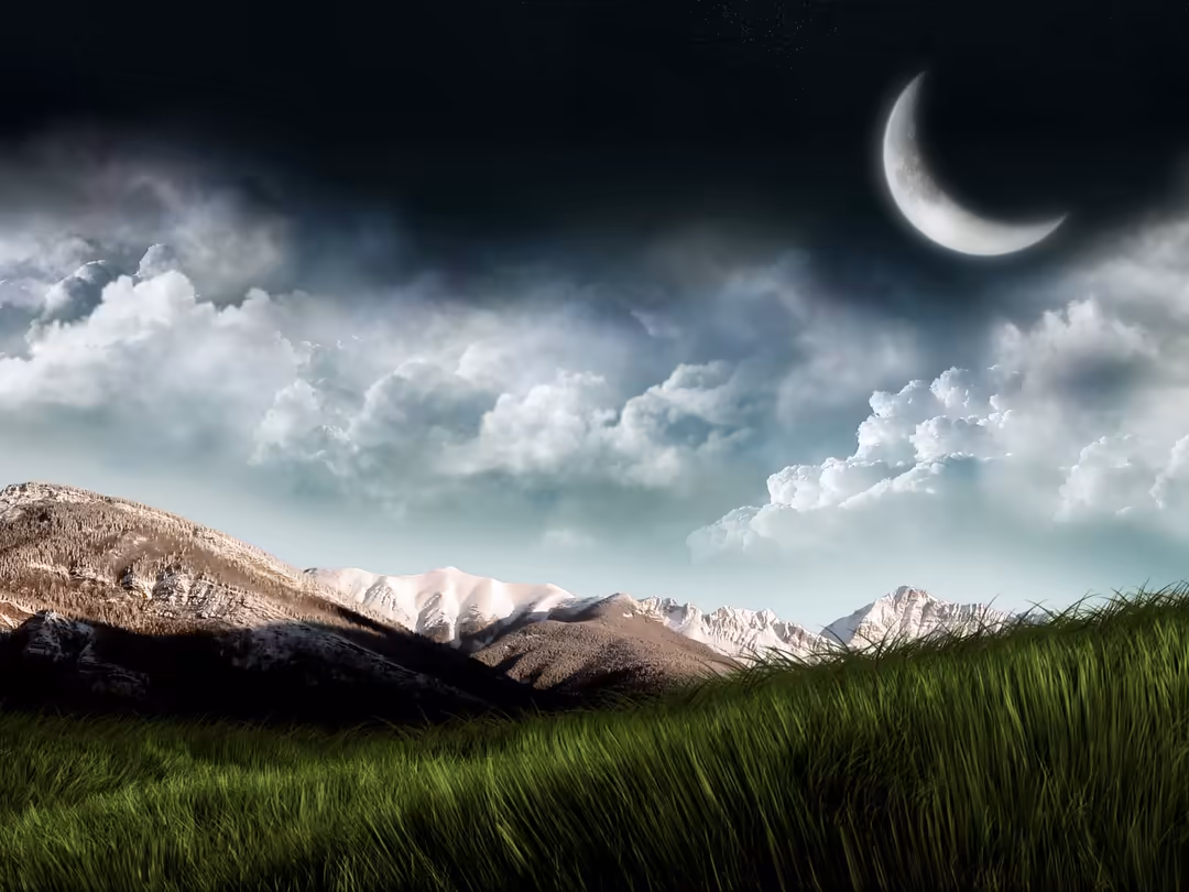 Crescent moon glowing above snow-capped mountains with white clouds and green meadow under starry night sky