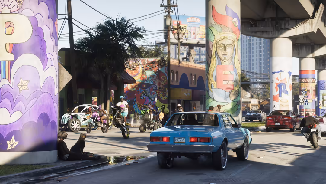 Vibrant street scene with colorful murals, blue classic car, motorcycles, and urban graffiti art under bridge