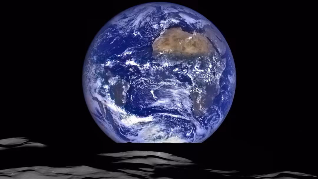 Earth viewed from the lunar surface, showing blue oceans, white clouds, and brown continents against the blackness of space.