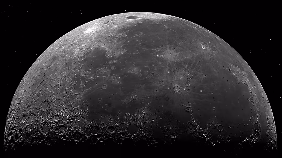 Detailed grayscale view of the moon's surface showing numerous craters and textures against a starry black space background
