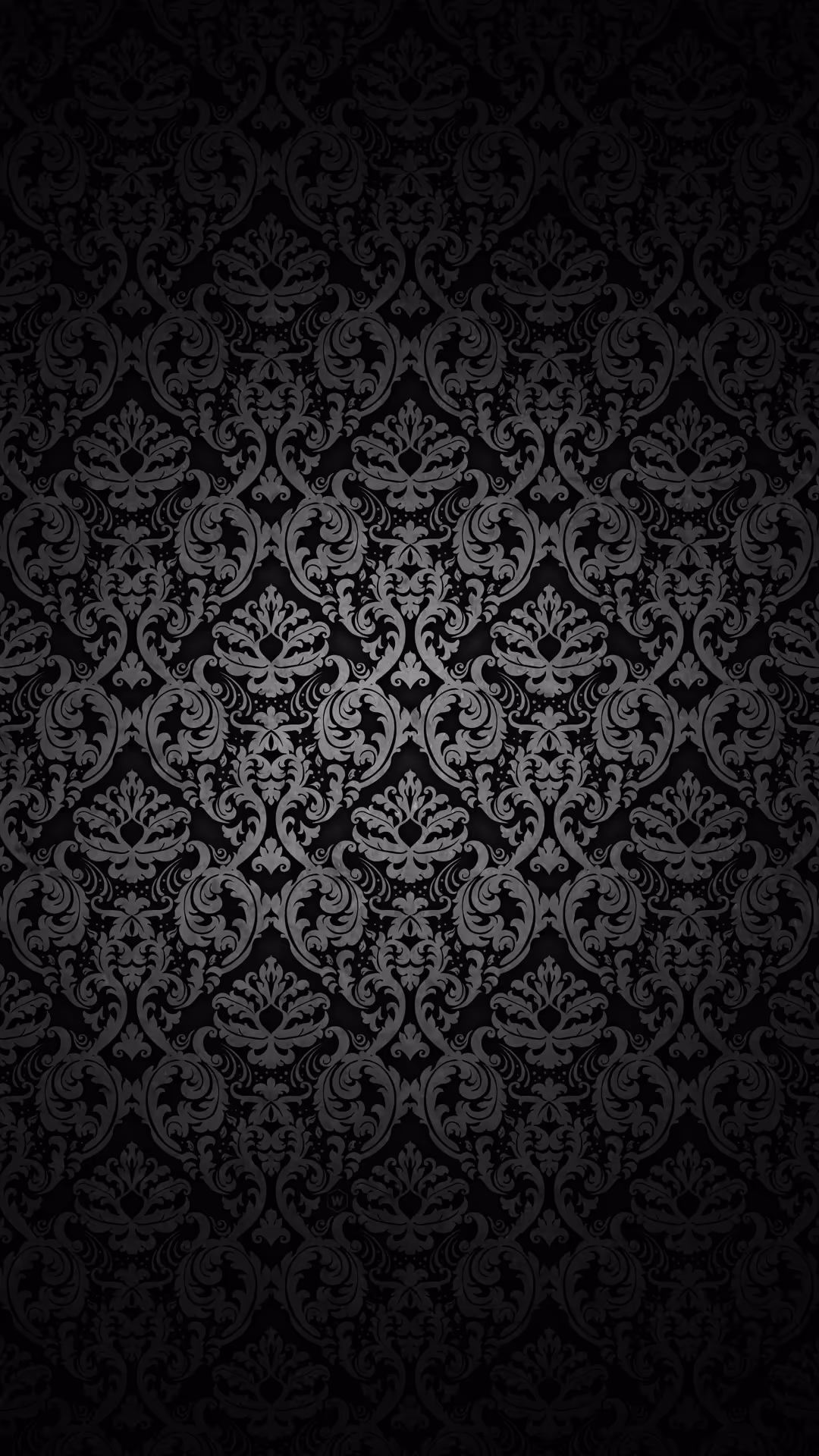 Elegant black damask pattern with intricate floral and scrollwork motifs repeating symmetrically across dark background