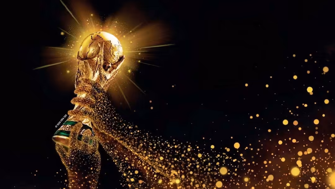 Golden FIFA World Cup trophy radiating brilliant light with glowing golden particles dispersing across black background in ce