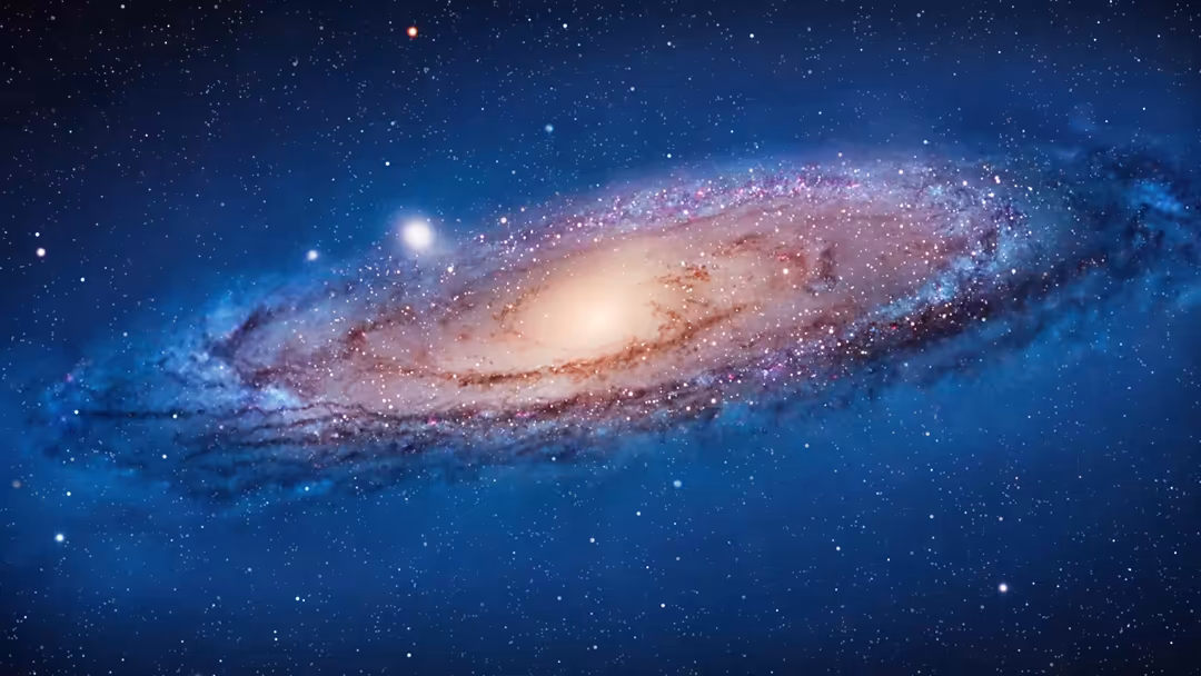 Majestic spiral galaxy with pink and white core surrounded by swirling dust lanes against a deep blue starfield with countles