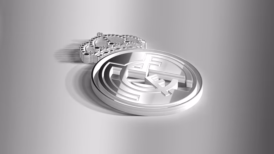 Metallic 3D rendered Real Madrid CF club emblem with silver chain and polished finish on gray background
