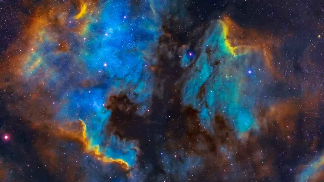 Vibrant cosmic nebula with turquoise and golden gas clouds surrounding dark dust formations and brilliant stars
