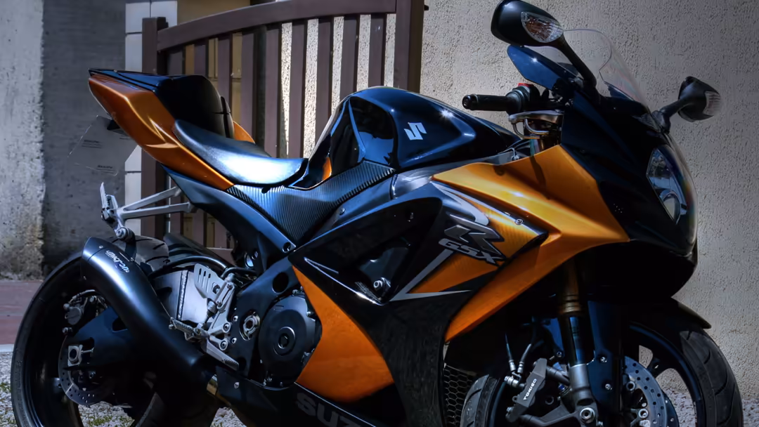 Orange and black sport motorcycle with metallic accents, showcasing aerodynamic fairing, chrome details, and professional rac