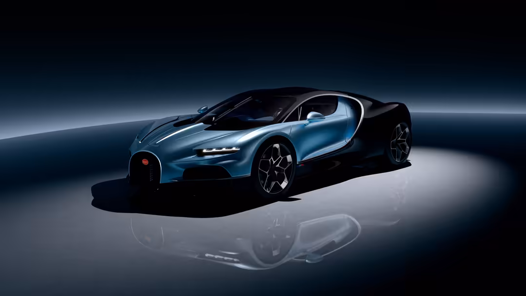 Sleek Bugatti Tourbillon hypercar with striking black and blue metallic finish displayed in dramatic studio lighting with ref