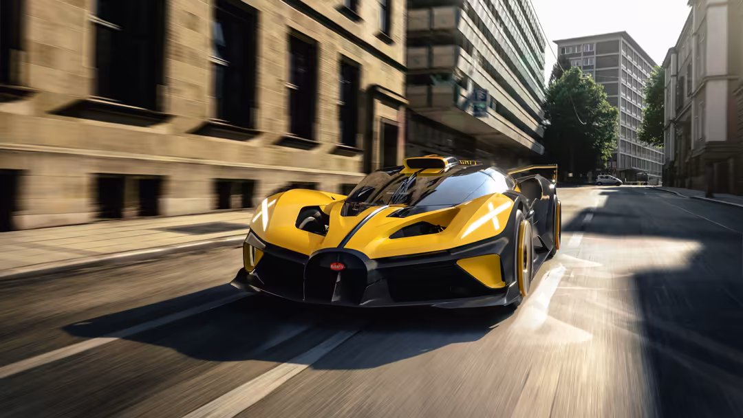 Yellow Bugatti Bolide hypercar racing through modern city streets with motion blur and tall buildings surrounding the vehicle