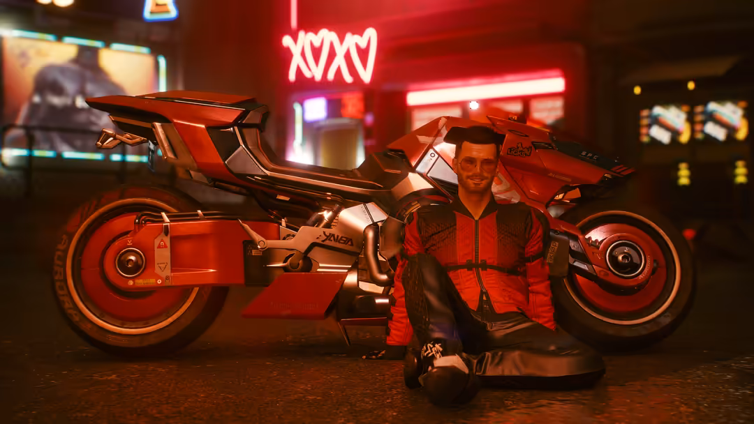 Man posing with futuristic red motorcycle under glowing neon signs in cyberpunk-themed environment with arcade screens