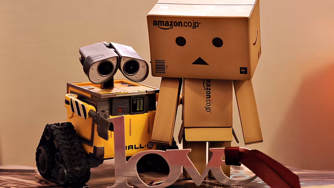 Adorable cardboard box robots and yellow toy vehicle arranged together in a playful scene with warm neutral background tones