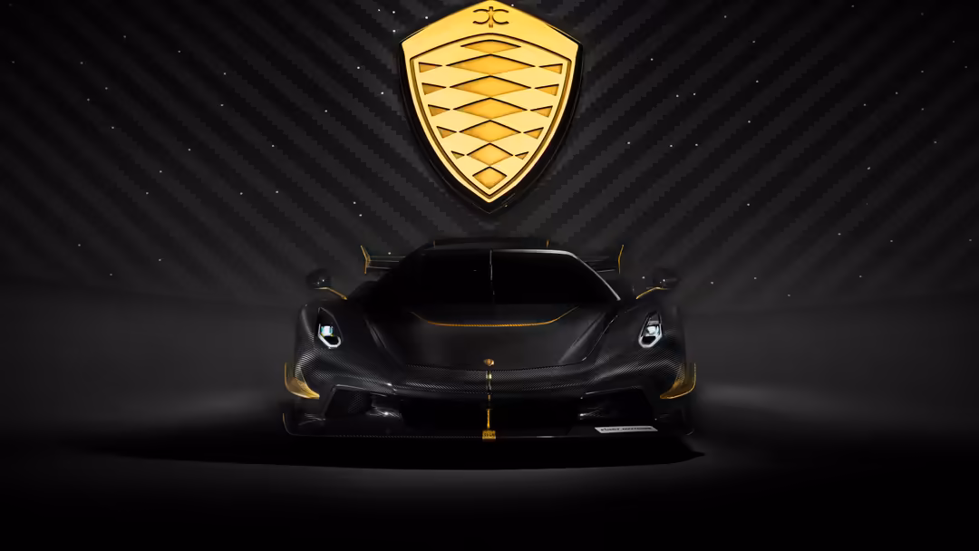 Black Koenigsegg Jesko hypercar with gold accents and shield logo on dark background with dramatic lighting