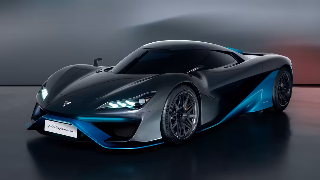 Sleek black sports car with vibrant turquoise accents, futuristic design, LED headlights, displayed in modern showroom settin