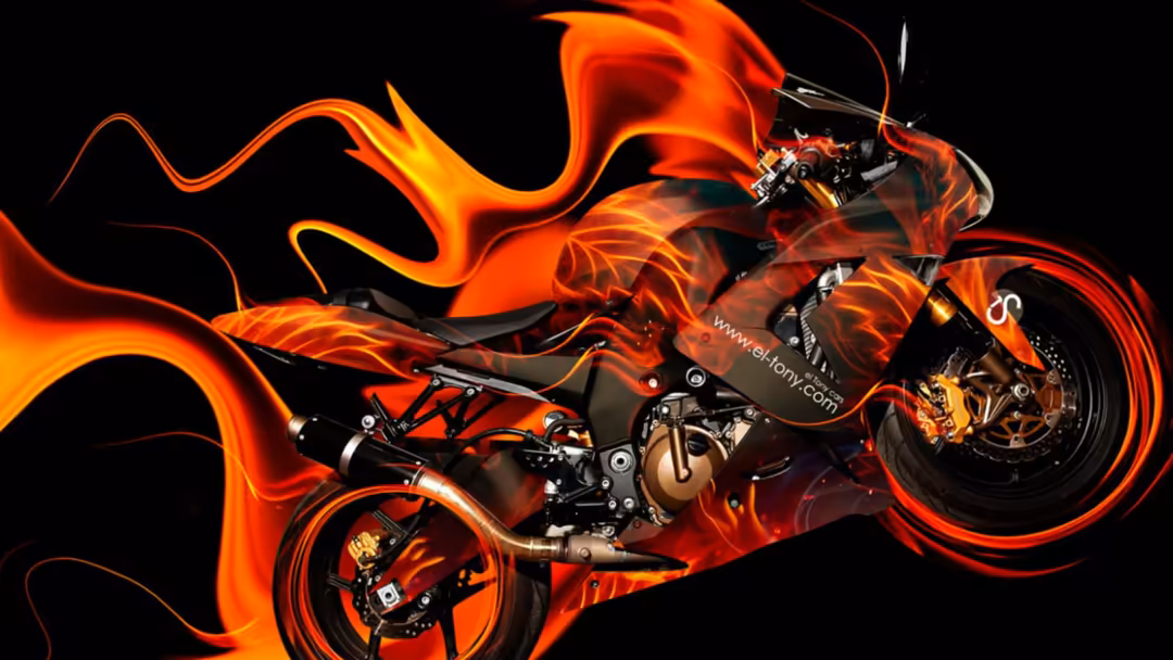 Red motorcycle engulfed in dramatic orange and yellow flames against a black background, creating a powerful dynamic motion e