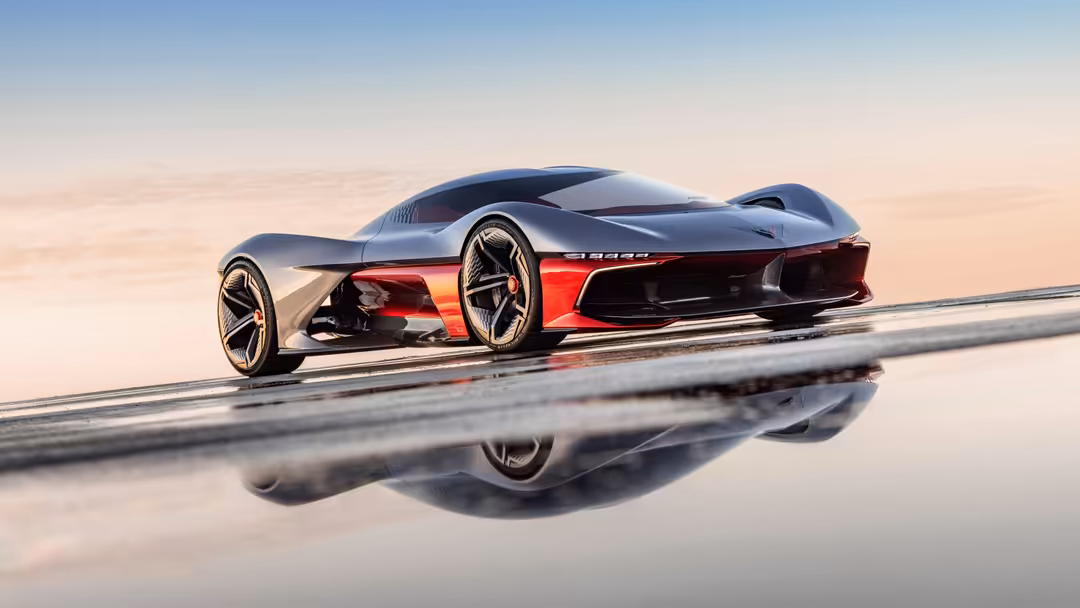 Futuristic red and silver Chevrolet Corvette concept car on a wet reflective surface with minimalist desert landscape
