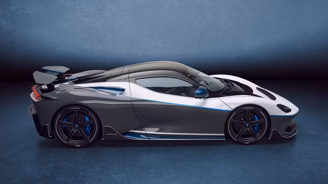 Sleek white and blue Pininfarina Battista Anniversario hypercar displayed in profile against a dark blue gradient backdrop