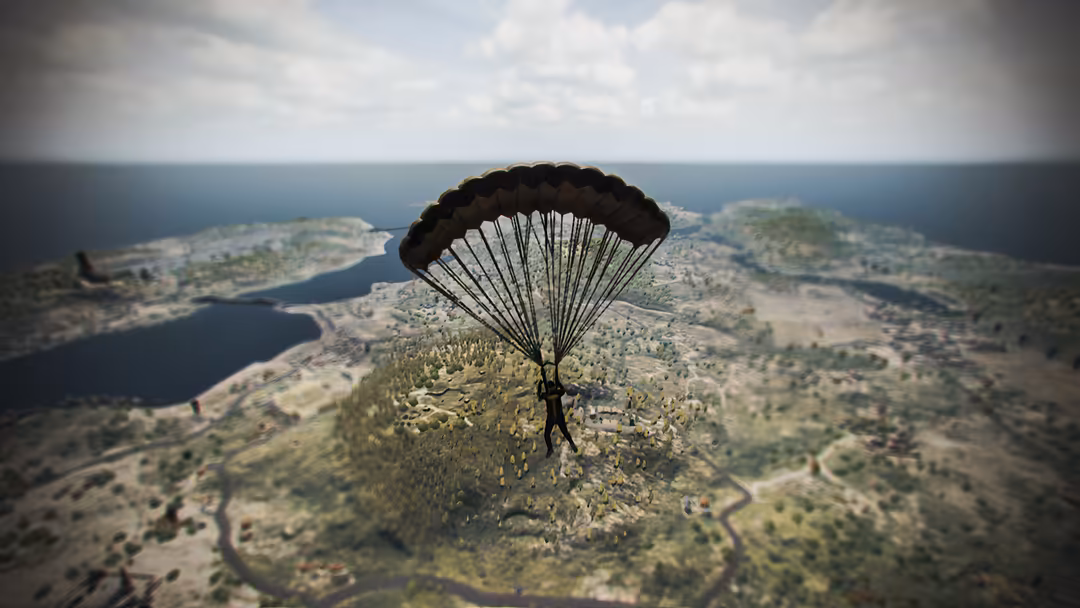 A skydiver with deployed parachute descending over a vast landscape with forests, lakes, and winding rivers visible below