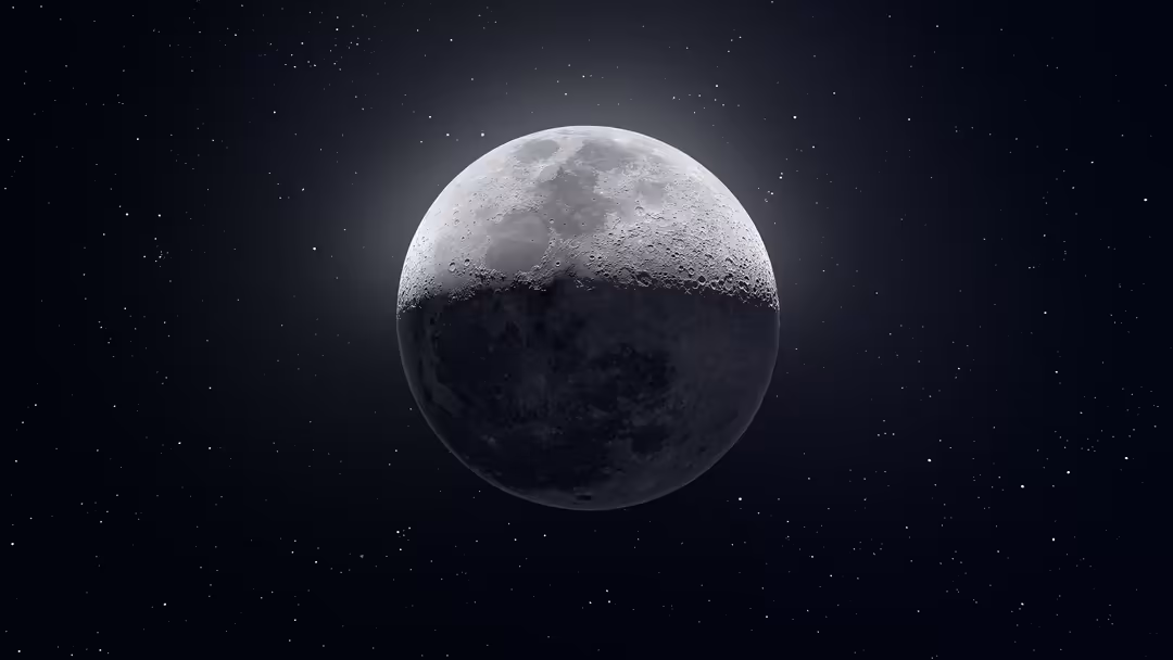 Half-illuminated moon with detailed crater surface against starry black space, showing dramatic lighting contrast between bri