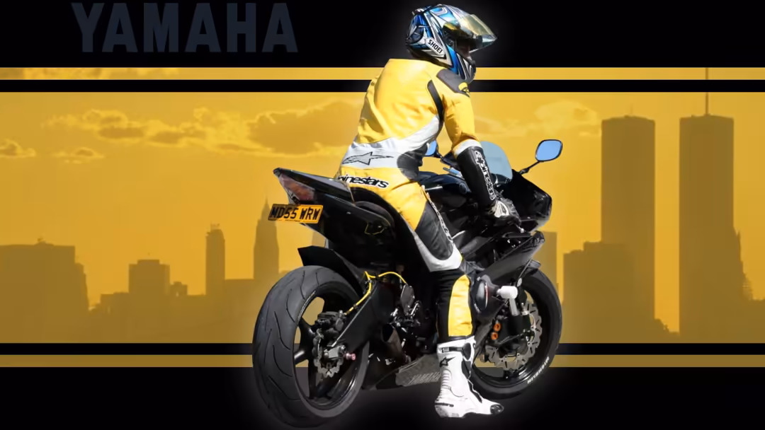 Rider in yellow jacket on black Yamaha motorcycle with city skyline backdrop and golden atmospheric lighting