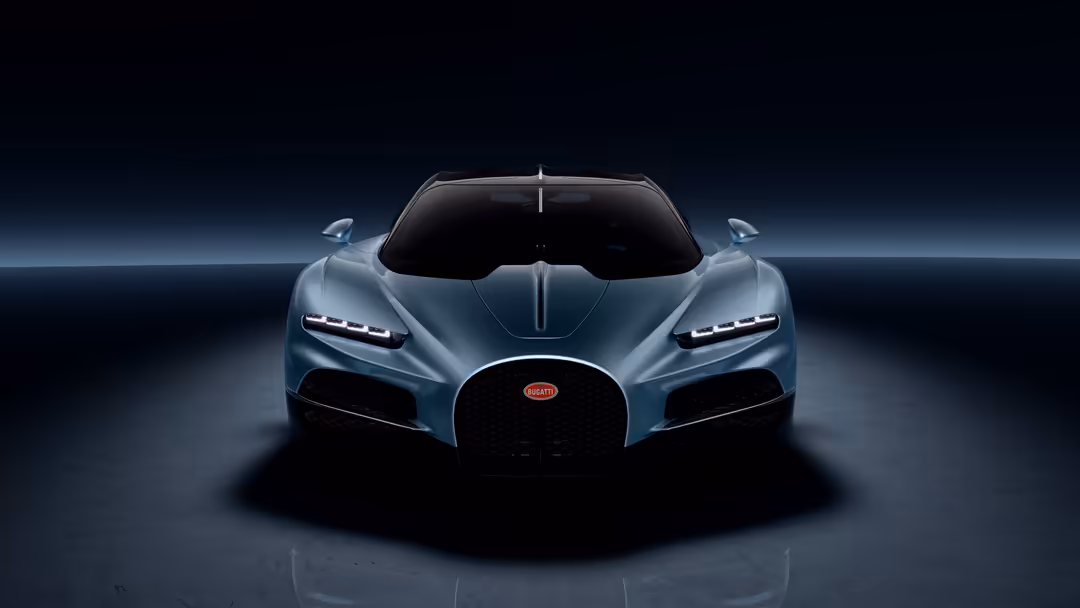 Silver Bugatti Tourbillon hypercar photographed head-on against dark background with dramatic lighting and reflective surface