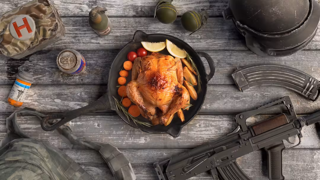 Overhead view of roasted chicken with vegetables in cast iron skillet surrounded by weapons and military gear on wooden surfa