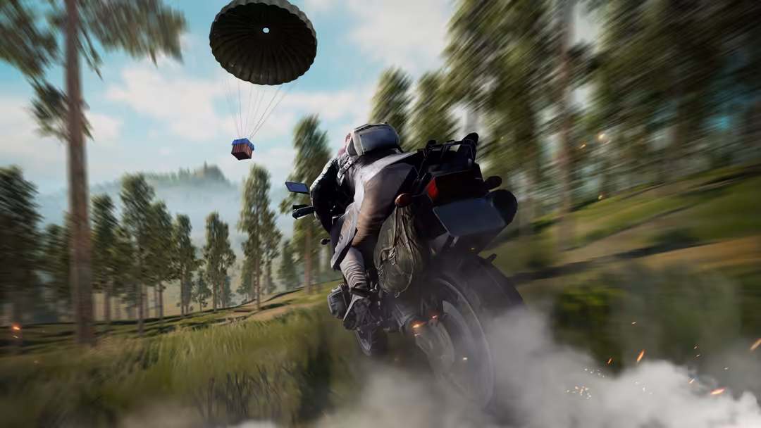 Intense PUBG scene featuring player on motorcycle with parachute descending overhead, racing through forested terrain with mo