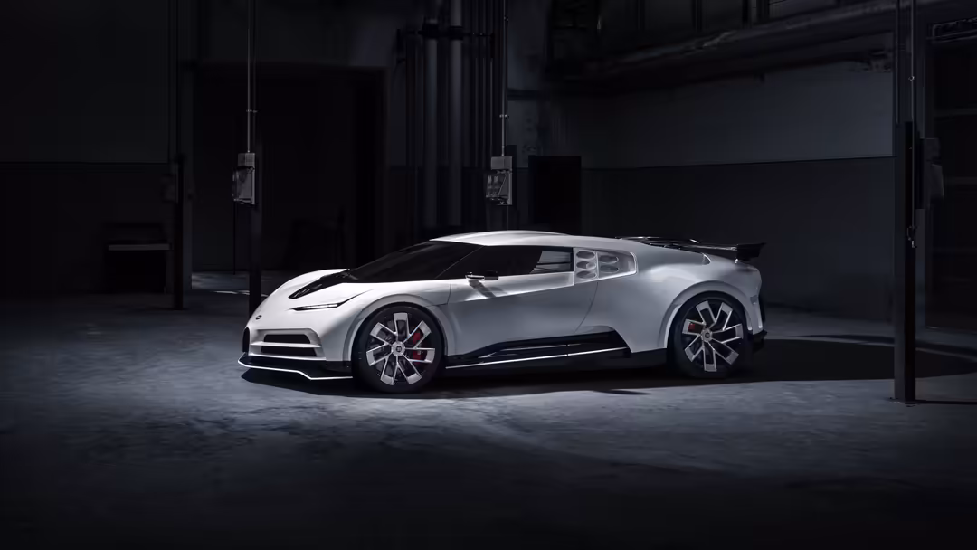 White Bugatti Centodieci hypercar displayed in dark industrial garage with dramatic lighting, showcasing its aerodynamic desi