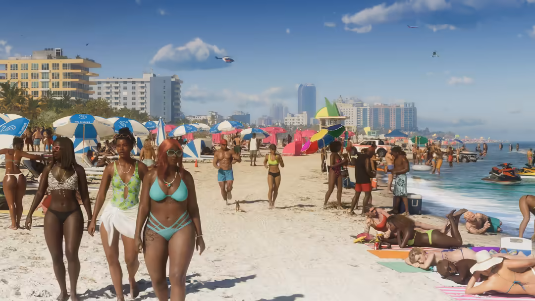 Crowded sunny beach with vibrant blue and pink umbrellas, beachgoers, high-rise buildings, and clear blue sky with white clou