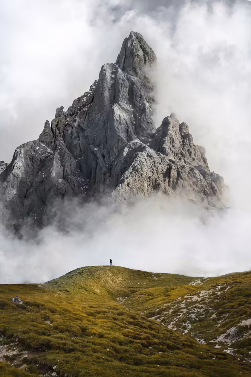 Solitary Hiker Amid Misty Mountains