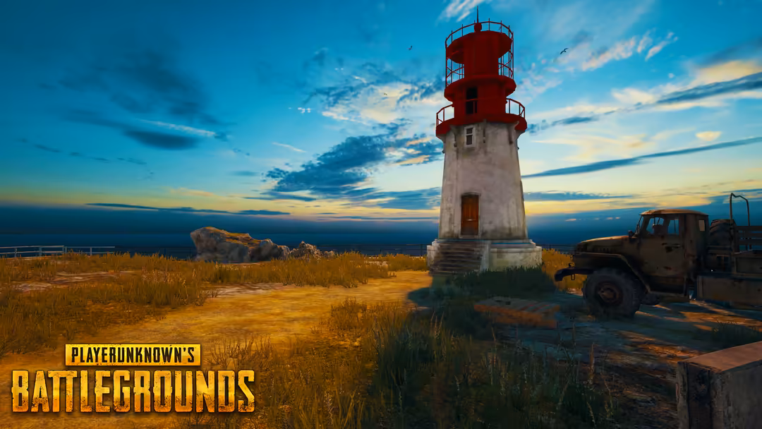 Abandoned red and white lighthouse standing on rocky coastal terrain with golden grass, rusty truck, and dramatic sunset sky