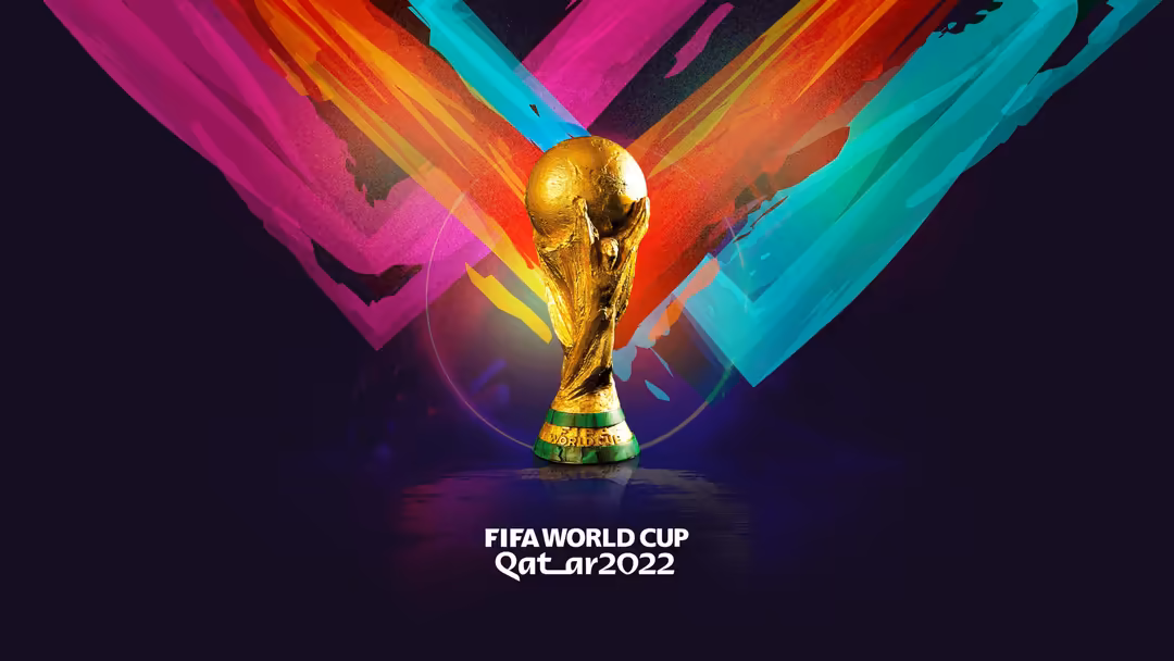 Golden FIFA World Cup trophy surrounded by vibrant rainbow-colored light rays emanating outward against a dark background