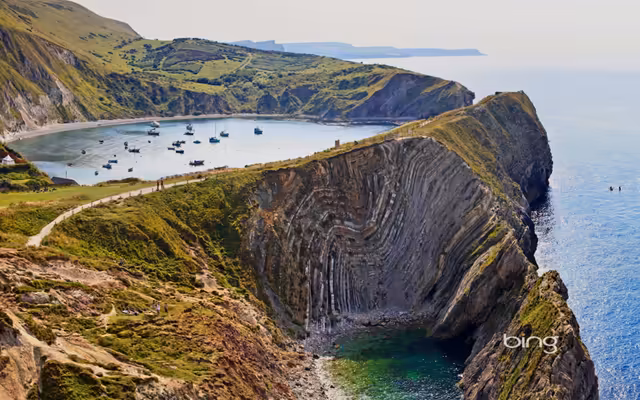 Dramatic Coastal Cliffs With Anchored Boats