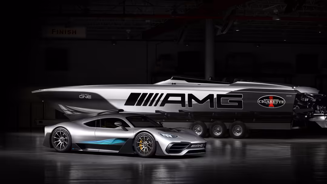Silver Mercedes-AMG Project One hypercar displayed alongside its support vehicle in an industrial hangar setting
