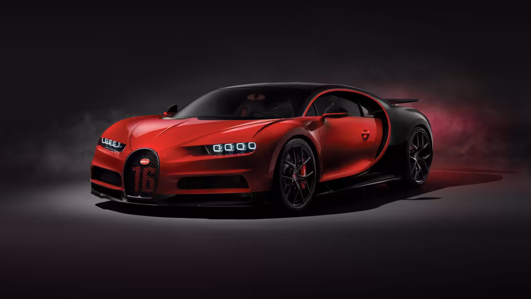 Sleek red Bugatti Chiron Sport hypercar with open door displayed against dark dramatic background with moody lighting