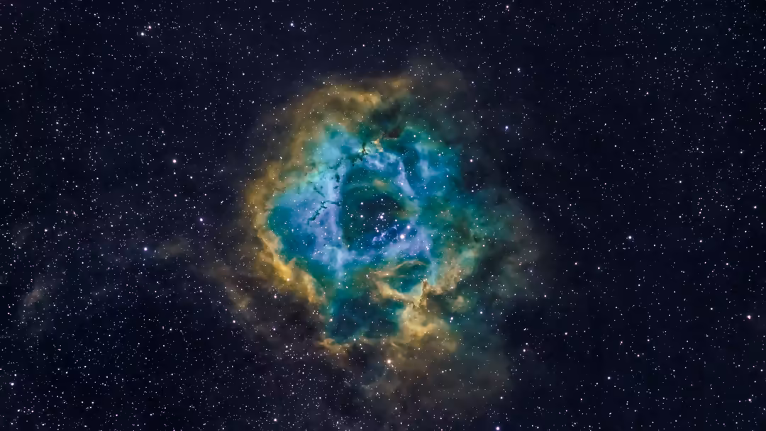 Colorful rosette nebula with turquoise and golden dust clouds surrounded by stars in deep space
