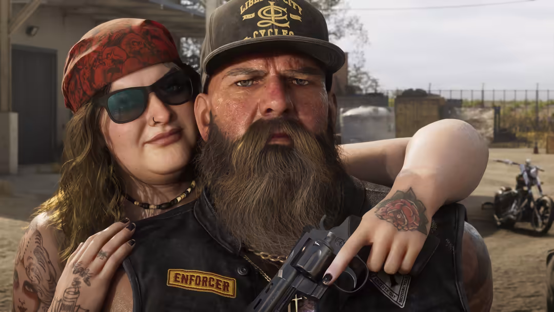 Two tattooed bikers in desert compound setting, one wearing red bandana and sunglasses, other in black cap holding revolver,