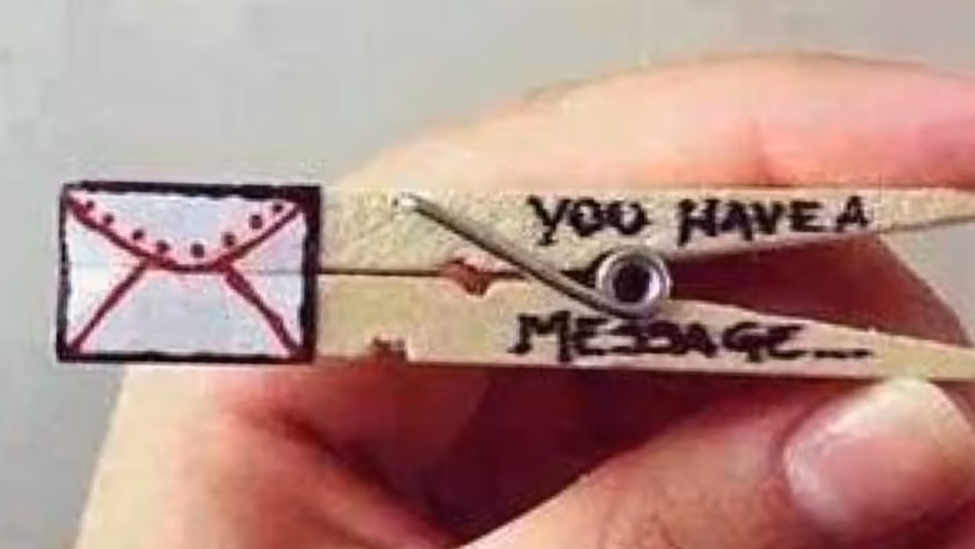 Hand holding clothespin with envelope illustration and text saying 'you have a message', cute aesthetic minimal art style