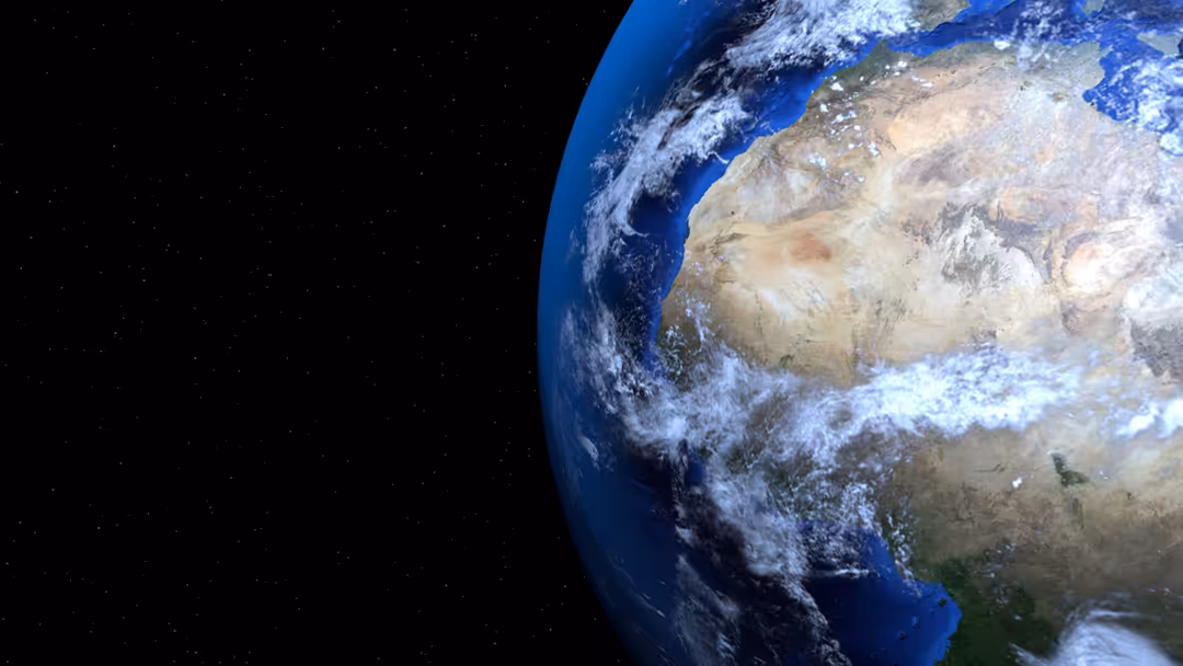 Earth viewed from space showing blue oceans, white clouds, continents, and Africa with stars in the background
