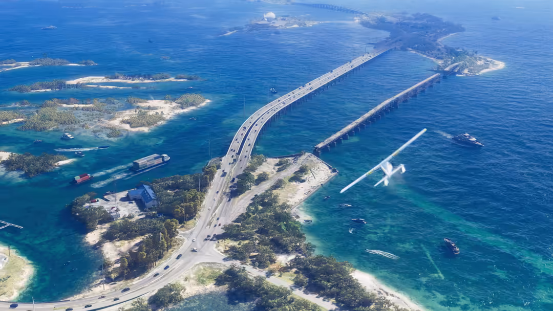Aerial view of a massive engineering bridge spanning turquoise waters with islands, boats, and an aircraft flying overhead in